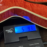 Used Collings I-30 LC Faded Cherry on scale displaying weight.