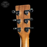 Close-up of a guitar headstock with tuning pegs on a black background, featuring the Tone Shop logo.