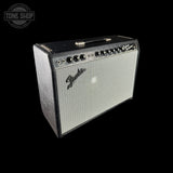 A vintage Fender Jazz Bass amplifier head with a black cabinet, silver grille, and chrome controls, shown against a solid black background with a Tone Shop watermark in the top-left corner.