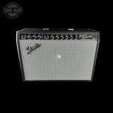 A Fender Deluxe Reverb 40 guitar amplifier with a black cabinet, silver grille, and black control panel, shown against a solid black background with a Tone Shop watermark in the top left corner.