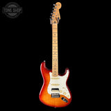 Electric guitar with a sunburst finish on a black background, featuring the Tone Shop logo.