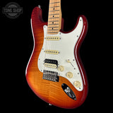 Electric guitar with a sunburst finish on a black background, featuring the Tone Shop logo.