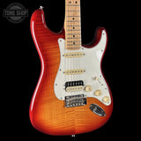 Electric guitar with a red and brown finish on a black background, featuring the Tone Shop logo.