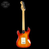 Electric guitar with a sunburst finish on a black background, featuring the Tone Shop logo.