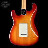 Fender electric guitar with a sunburst finish on a black background