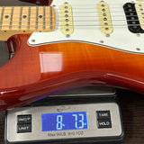 Electric guitar on a digital scale displaying weight