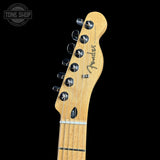 Close-up of a Fender Telecaster electric guitar headstock and upper neck, shown in natural wood finish against a black background with a Tone Shop watermark in the top left.