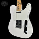A white electric guitar with a maple neck, black pickguard, and chrome hardware, shown against a solid black background with a Tone Shop watermark in the top-left corner.