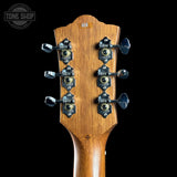 Guitar headstock with tuning pegs on a black background, featuring the Tone Shop logo.