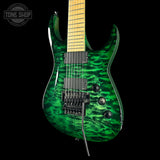 A green flamed maple electric guitar with a black bridge and pickups, shown against a solid black background with a Tone Shop watermark in the top left corner.