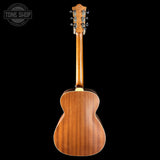 Back view of a wooden acoustic guitar with 'Tone Shop' logo in the corner.