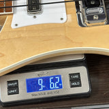 Bass guitar on a digital scale displaying weight