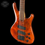 Electric bass guitar with a glossy finish on a black background, featuring the Tone Shop logo.