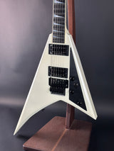 White electric guitar with a unique body shape on a dark background