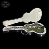 Electric guitar in a hard case with 'Tone Shop' logo in the corner.