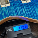 PRS Select Wood Library McCarty Trem 10 Top Arctic Blue on scale displaying weight.
