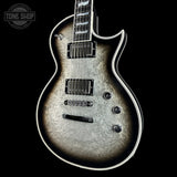 Silver electric guitar with a black background