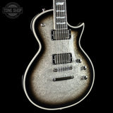 Electric guitar with a textured finish on a black background, featuring the Tone Shop logo.