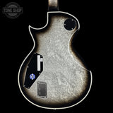 Close-up of a guitar body with visible brand logo in the corner