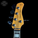 Guitar headstock with 'Marcus Miller' branding on a black background