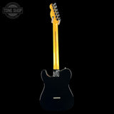 A black electric guitar shown from the back, featuring a glossy black body, a natural yellow maple neck, and chrome hardware, set against a solid black background with a Tone Shop watermark in the top-left corner.