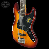 Electric bass guitar with a sunburst finish on a black background, featuring the Tone Shop logo.