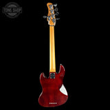 Red electric guitar with a black background, featuring the Tone Shop logo.