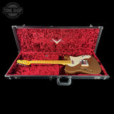 Electric guitar in a red-lined case with a visible brand logo on a black background