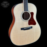 Acoustic guitar with a visible brand logo on a black background