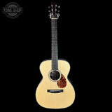 Acoustic guitar with a visible brand logo on a white background