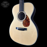 Acoustic guitar with a visible brand logo in the corner