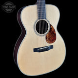 Acoustic guitar with a visible brand logo in the corner