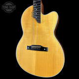 Acoustic guitar with a visible brand logo on a black background