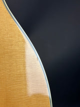 Close-up of a guitar's soundboard with a dark background