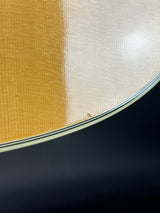 Close-up of a guitar's soundboard with a dark background