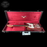 A Fender Telecaster electric guitar with a dark red sparkle finish, displayed inside an open black hard case with a red velvet interior. The Fender logo is visible on the headstock and inside the case lid.