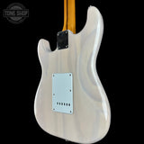 The back of a Fender Stratocaster electric guitar with a glossy white/cream finish, featuring a white pickguard and a maple neck visible at the top, set against a solid black background.