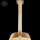 Close-up of a guitar's back and neck with 'Tone Shop' branding.