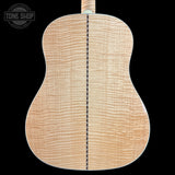 Back view of a wooden acoustic guitar with 'Tone Shop' logo.
