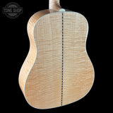 Back view of a acoustic guitar with 'Tone Shop' logo in the corner.