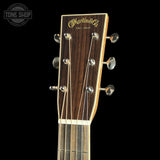 Martin & Co. acoustic guitar headstock in dark brown wood with gold lettering, six silver tuning pegs, and six strings, shown against a solid black background with a Tone Shop watermark in the top-left corner.