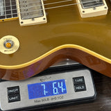 Electric guitar on a digital scale displaying weight
