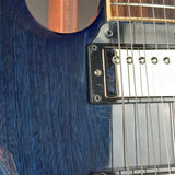 Close-up of a blue electric guitar body showing the wood grain finish, black hardware, silver pickups, and part of the fretboard.