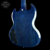 The back of a blue electric guitar with a glossy blue finish, featuring a black pickguard and silver hardware, shown against a black background with a Tone Shop watermark in the top left corner.