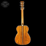 Wooden acoustic guitar on a black background with 'Tone Shop' logo.