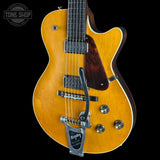 A classic electric guitar with a natural maple top and dark brown sides, featuring a black pickguard, dual humbucker pickups, and a silver tremolo system. The brand 'Tone Shop' is visible as a watermark in the top-left corner.