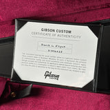 A close-up of a Gibson Custom Certificate of Authenticity card inside a black presentation case, placed on a deep burgundy fabric background. The card is addressed to Davis in Flight and includes the Gibson Custom logo.