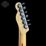 Close-up of the headstock of a Fender electric guitar in a natural maple finish, showing six silver tuning pegs and model text 'AJ110E-326' on a solid black background.