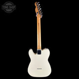 A white electric guitar shown from the back against a solid black background, with a Tone Shop watermark in the top-left corner.