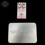 Photo ofUsed Black Country Customs Monolith Distortion Pedal and Silver Box against a black background.